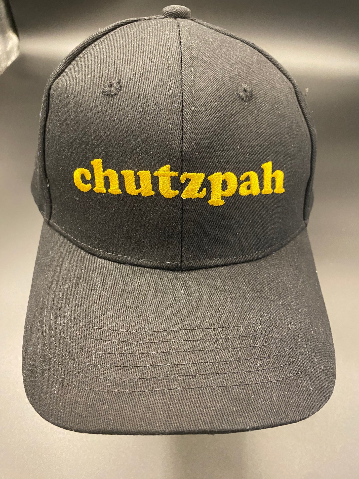 Cap Off Your Chutzpah (Gold Edition) - A black high quality pure cotton cap with velcro back for easy adjustment. Gold embroidery on the front reading CHUTZPAH. Who doesn't love yiddish?