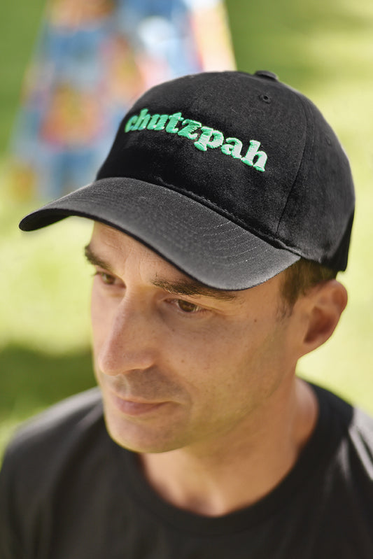 Cap Off Your Chutzpah - Full of chutzpah? This is the cap for you. Black, pure, thick, brushed cotton cap with five eyelets, putting your cojones on display. Bottle green embroidery reads CHUTZPAH. One size fits most, velcro fastening at the back for those less dextrous among us.  